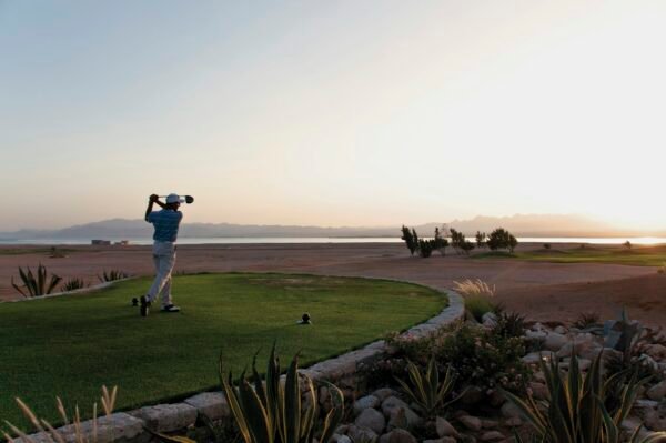 Egypt, Man playing golf on golf course