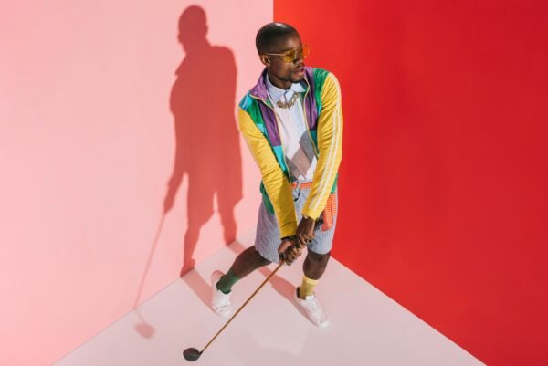 high angle view of stylish african american man playing golf